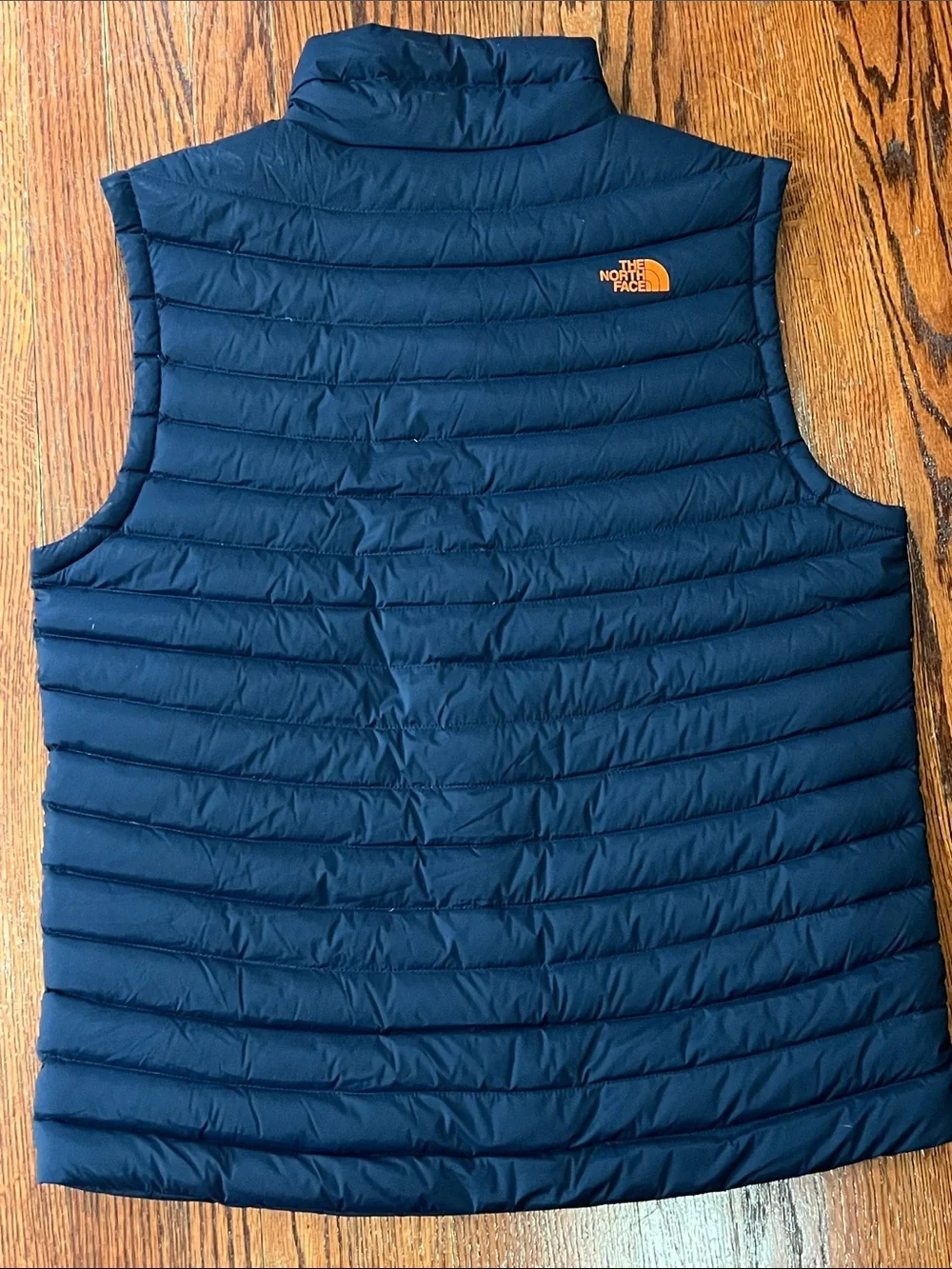 The North Face Black Quilted Down Vest with Blue Lining and Orange Logo